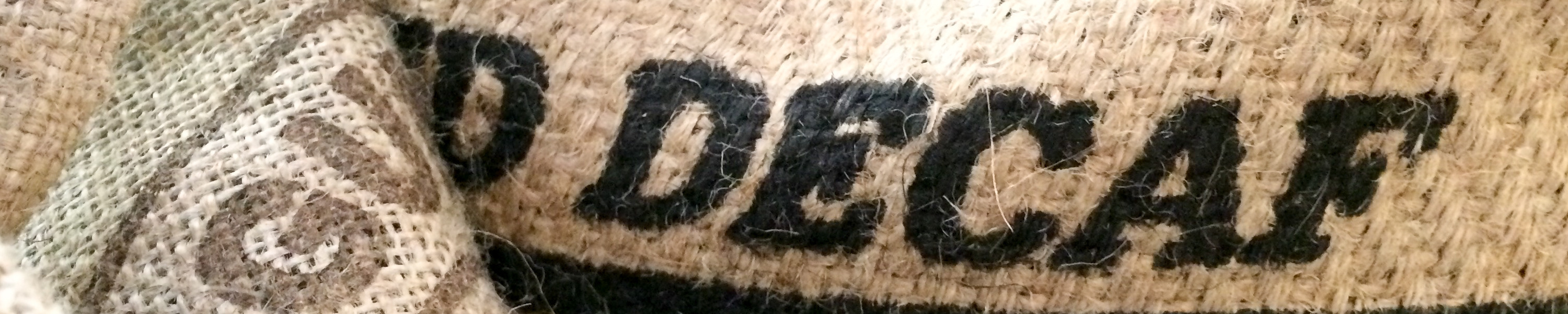 Burlap Coffee bean bags / Steve Dunning Burlap coffee bean bags on floor with organic imported coffee