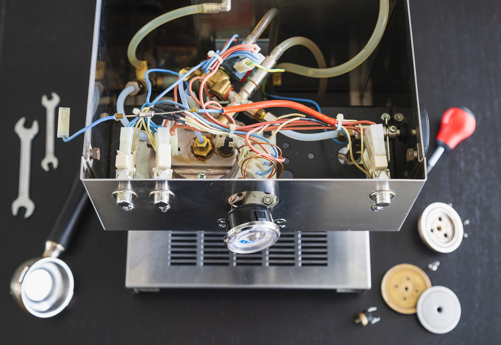 The interior of a defective espressomachine, ready to be repaired.