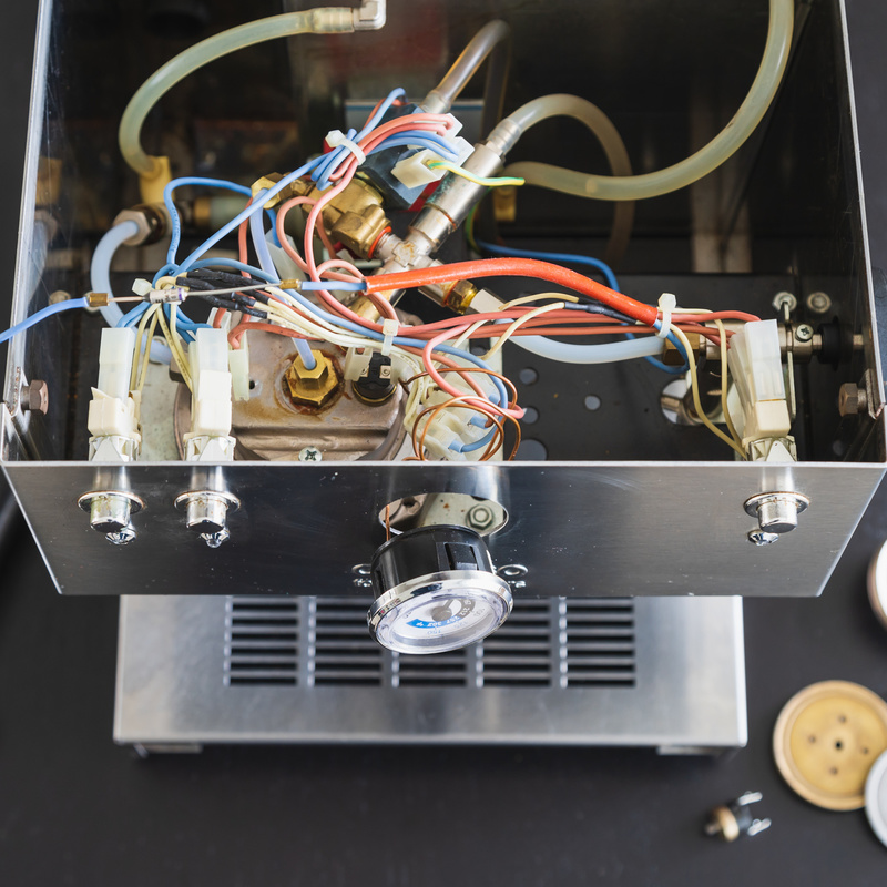 The interior of a defective espressomachine, ready to be repaired.