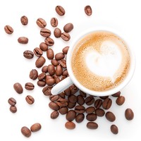 Small cup of cappuccino with coffee beans and heart shaped milk foam, top view isolated on white background